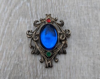 Royal Blue Glass Cabochon, Ruby Red and Emerald Green Rhinestone, and Silver Tone Metal Georgian Style Shield Brooch