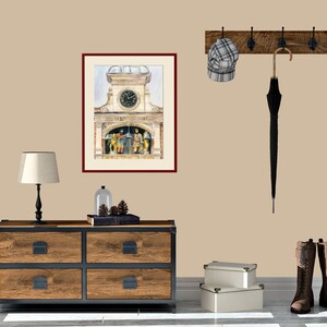 May include: A framed watercolor painting of a clock tower with a clock face and figures on the side. The painting is hanging on a beige wall with a wooden coat rack with a hat and umbrella hanging on it. A wooden dresser with four drawers is in the foreground.