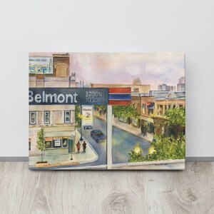 May include: Watercolor painting of a city street scene with a sign that reads "Belmont 3200N 1000W". The painting features buildings, streetlights, cars, and people walking.
