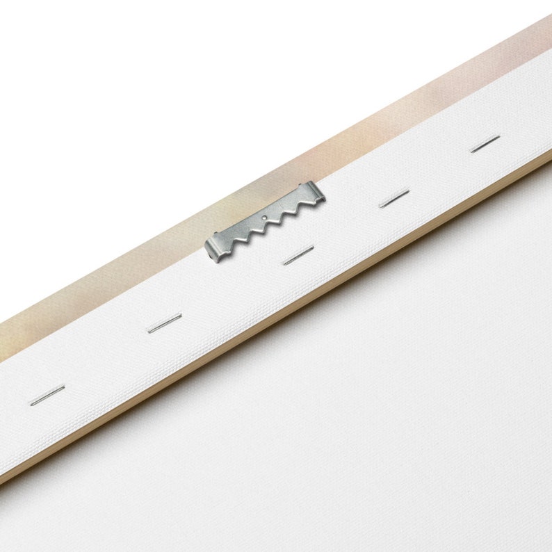 May include: Close-up of the back of a canvas print, showing a metal hanging hook and small nails securing the canvas to the wooden frame.