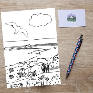 May include: A black and white line drawing of a seascape with a seagull flying overhead, a cloud in the sky, and a winding path leading to a small village in the distance.