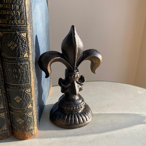 Gietijzeren Fleur De Lis deurstopper/boekensteun