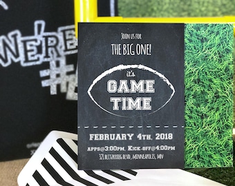 May include: A black and white invitation with a chalkboard background. The invitation reads "Join us for the big one! It's game time." The date is February 4th, 2018. The time is 3:00 PM for apps and 4:00 PM for kick-off. The location is 321 Blitzkrieg Blvd, Minneapolis, MN.