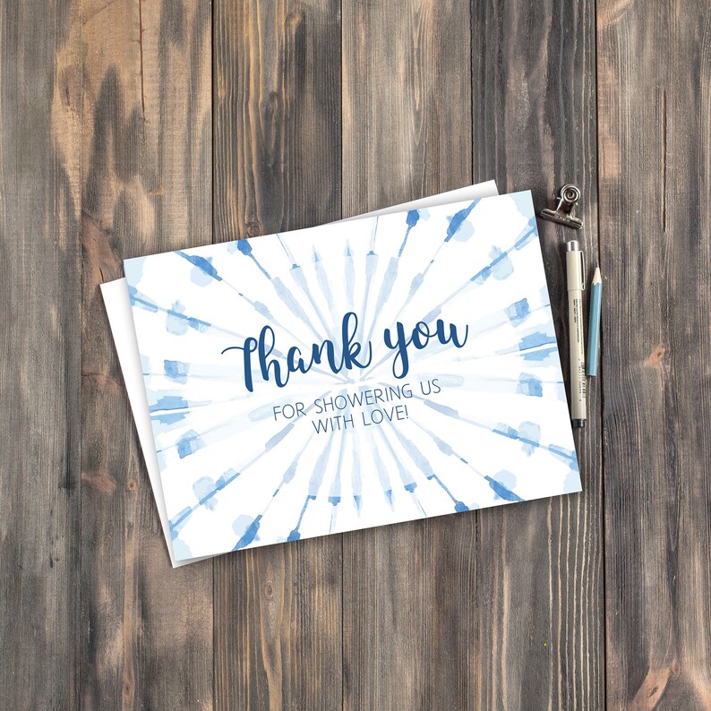 May include: A white thank you card with a blue watercolor design. The text "Thank you for showering us with love!" is printed in blue.
