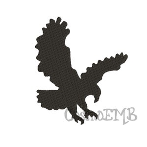 May include: Black embroidered silhouette of an eagle in flight, wings spread wide. The eagle is depicted with detailed feathering and a sharp beak, set against a clean white background. The text "CosmoEMB" is in the lower right corner.