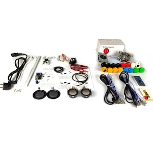 May include: A DIY arcade kit with a joystick, buttons, speakers, wiring, and a circuit board. The kit includes a variety of colored buttons, including red, yellow, blue, and green. The kit also includes a power adapter and instructions.