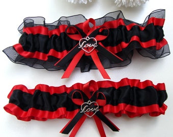 May include: A black and red garter with a silver heart charm that says "Love".