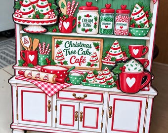 May include: A decorative wooden sign featuring a kitchen hutch illustration with the text Christmas Tree Cake Café. The design includes red and white holiday-themed kitchenware, jars labeled Cream Icing, Sprinkles, and Peppermint, and cookies.