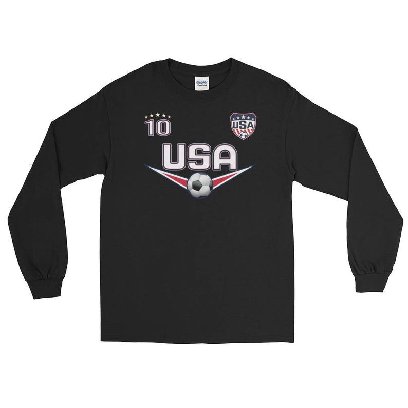 May include: Black long-sleeve t-shirt with a soccer theme. It features a white and red USA logo, a soccer ball, and the number 10.