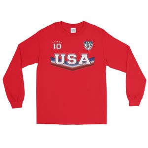 May include: Red long-sleeve shirt with a white and blue USA graphic, a star pattern, and the number 10.