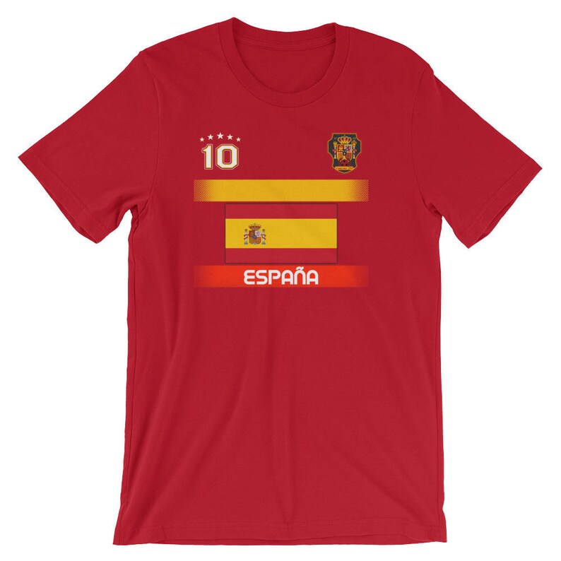 May include: Red t-shirt featuring the Spanish flag design. The shirt has the number 10 and the word "Espa&ntilde;a" printed on the front. The Spanish coat of arms is also visible.