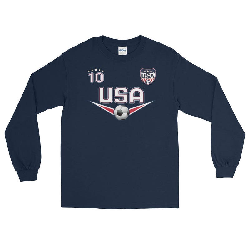 May include: Navy blue long-sleeve shirt with a soccer ball graphic and the text "USA" and "10".