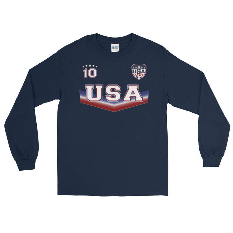 May include: Navy blue long-sleeve shirt with a red, white, and blue USA graphic. The shirt has a number 10 on the front and a small USA logo with stars.