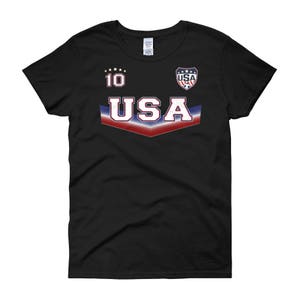 May include: Black women's t-shirt with a red, white, and blue USA graphic and the number 10 on the front.