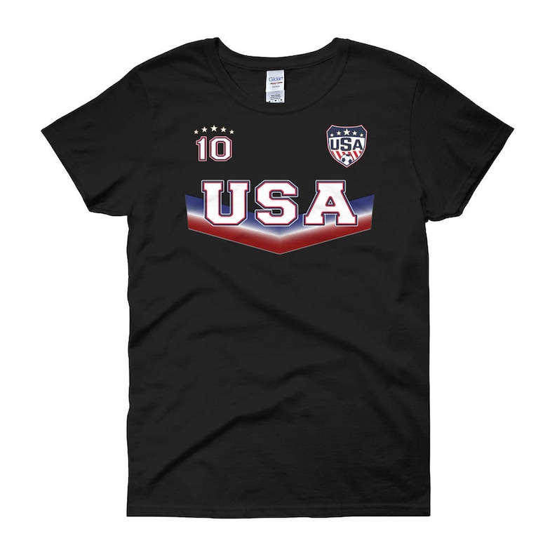 May include: Black women's t-shirt with a red, white, and blue USA graphic and the number 10 on the front.