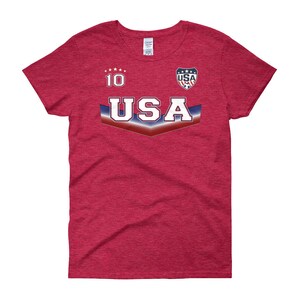 May include: Red t-shirt with a white and blue USA graphic and the number 10 on the front.