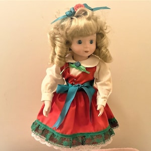 Vintage 16 inch Tall Porcelain Doll with Stand.Dressed in Green and Red Clothing