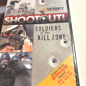 May include: DVD case for "Shootout! Soldiers of the Kill Zone" from the History Channel Club. The cover features images of soldiers and firearms, with the title in large, bold letters. Includes a bonus segment about the Battle of the Bulge.