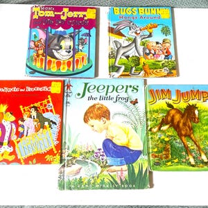 May include: A collection of five vintage children's books. Titles include "Tom & Jerry," "Bugs Bunny," "Bedknobs and Broomstick," "Jeepers the Little Frog," and "Jim Jump." The books feature colorful illustrations and text.