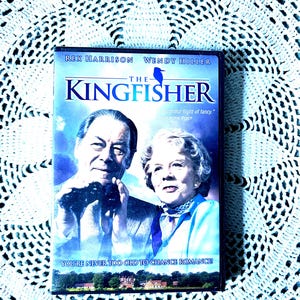 May include: A DVD case for "The Kingfisher" movie. The cover features Rex Harrison and Wendy Hiller. The title is in blue, with a blue bird graphic. The tagline reads, "You're never too old to chance romance!"