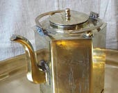 Chinese brass teapot with a strainer. Engraved with lansdscapes.