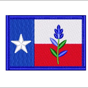 May include: Embroidered patch depicting the Texas state flag. The design includes a blue field with a white star, a white stripe, a red stripe, and a bluebonnet flower. The patch has a blue border.
