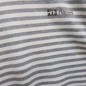 May include: White and grey striped t-shirt with a small Hanes logo embroidered on the front.