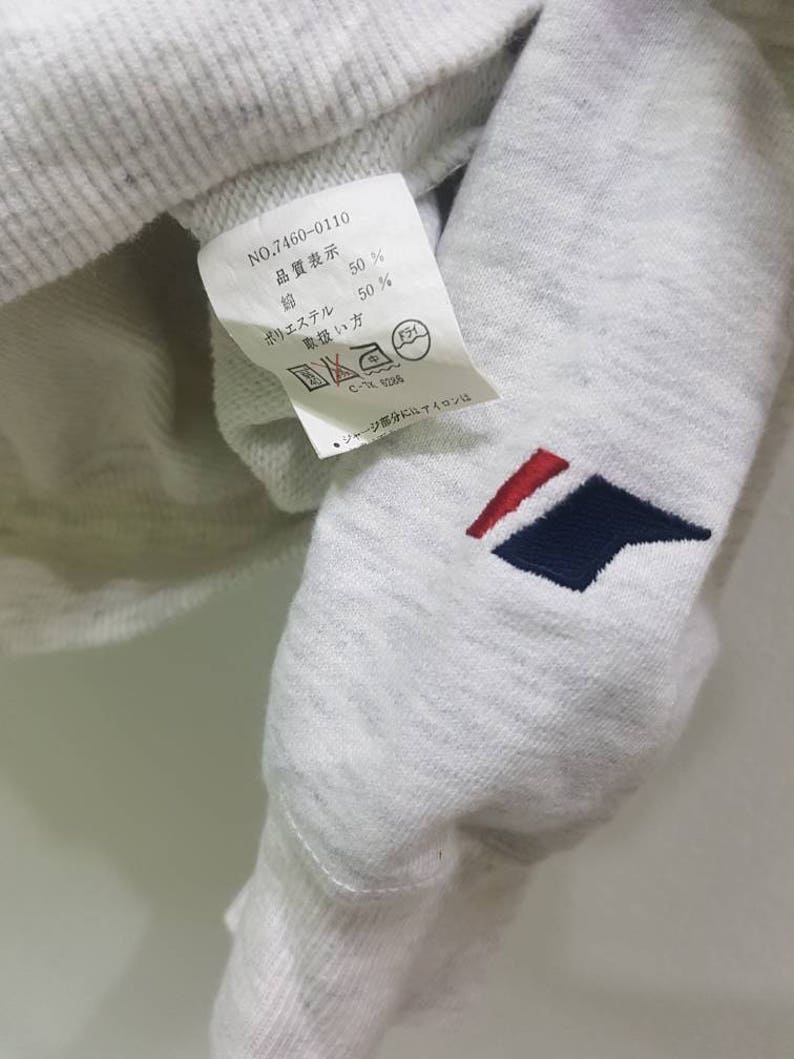 May include: A white tag with black text that reads "NO.7460-0110", "品質表示", "ポリエステル 50%", "綿 50%", "取扱い方", "C-1288", and "●ジャージ部分にはアイロンは".