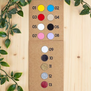 May include: A color chart with 13 different colors, numbered 1 through 13. Colors 1-8 are non-glitter, and colors 9-13 are glitter. The text "TEXT COLORS" is at the top of the chart.