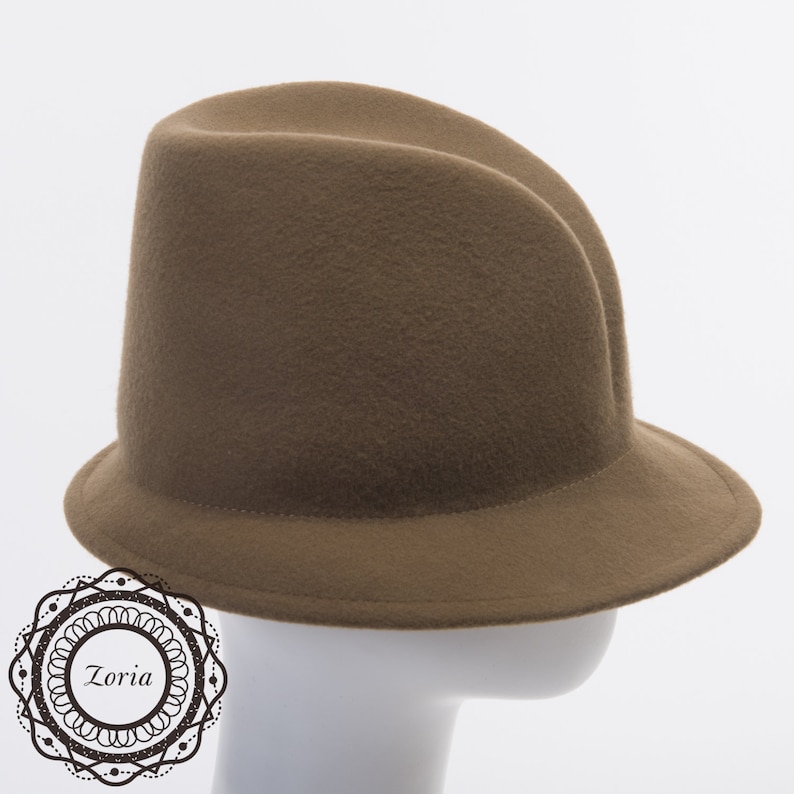 May include: A brown felt fedora hat with a wide brim. The hat is on a white mannequin head.