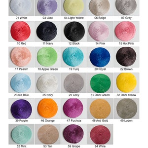 May include: A color card titled Zoria AD01BP featuring thirty circular woven straw discs in various colors including white, lilac, yellow, beige, grey, red, navy, black, pink, peach, green, turquoise, royal blue, brown, ivory, purple, orange, fuchsia, gold, and wine.