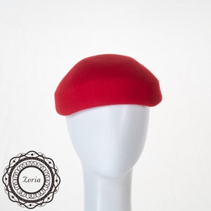 May include: A solid red felt cloche hat.