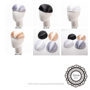 May include: A collection of dome-shaped pillbox hat bases in silver, black, white, and nature colours. The hats are shown individually on mannequin heads and grouped together in sets. The image includes the text Zoria Millinery Materials Trimming & Accessories.