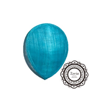 May include: A turquoise blue sinamay hat base, a type of fabric used for millinery, with a smooth, slightly textured surface.