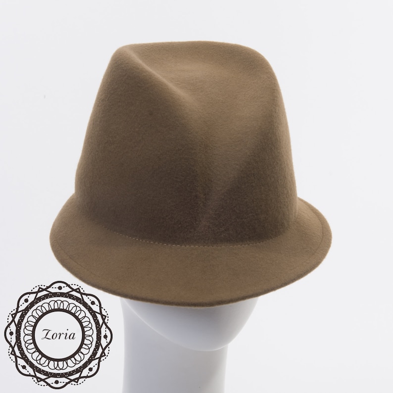 May include: A brown felt fedora hat with a wide brim. The hat is on a white mannequin head.