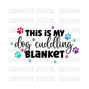 May include: This is my dog cuddling blanket with paw print designs in pink, blue, teal, and purple.