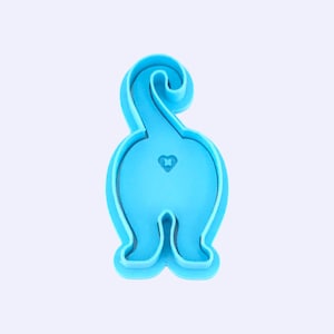 May include: A light blue cat butt-shaped cookie cutter. The cutter has a heart-shaped detail and a curled tail. The design is a playful and whimsical representation of a cat's rear end, perfect for baking themed treats.