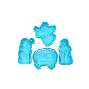 May include: A set of four light blue plastic cookie cutters in the shapes of a nativity scene: an angel, a manger, Mary, and Joseph. The cutters are designed with detailed outlines for easy use and are ideal for holiday baking.