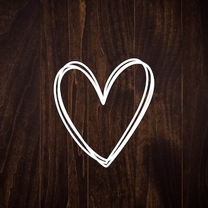 May include: A white heart drawn on a dark brown wooden background.