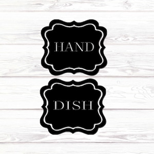 May include: Two black and white signs with rounded corners and decorative edges. The top sign says "HAND" and the bottom sign says "DISH".