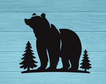 May include: A black silhouette graphic featuring a large bear standing on a curved ground line between two pine trees. The design is presented against a light blue background with a horizontal wood grain texture throughout the entire image.