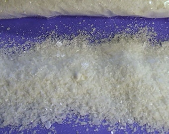 May include: A clear plastic bag containing a white powder labeled "TIN MORDANT Stannous Chloride 1 POUND (1 oz.= aprox 3 tsp.) use at 1/2 oz to the pound of fibre wear gloves while handling keep out of reach of children Distributed by www.aurorasilk.com"
