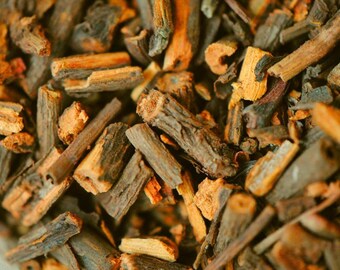 May include: Close-up of a pile of dried, brown, and orange bark pieces. The bark is broken into small, irregular pieces.