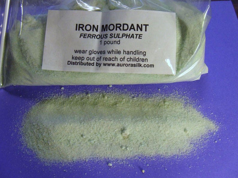 May include: A clear plastic bag containing a green powder labeled "IRON MORDANT FERROUS SULPHATE 1 pound". The label also includes safety instructions: "wear gloves while handling keep out of reach of children Distributed by www.aurorasilk.com".