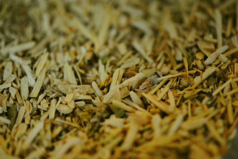 May include: Close-up of a mixture of dried herbs and spices, including yellow, brown, and green pieces.