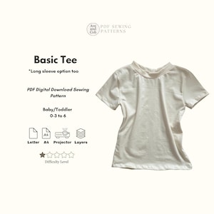 May include: A cream-colored short-sleeved Basic Tee shirt. The image includes text that reads "Basic Tee" and "PDF Digital Download Sewing Pattern" for Baby/Toddler sizes 0-3 to 6. The difficulty level is indicated by stars.