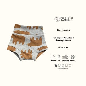 May include: Gray baby shorts with a brown bear pattern. The shorts have a high waistband and are designed for babies and toddlers. The image also includes text that says "Bummies" and "PDF Digital Download Sewing Pattern".