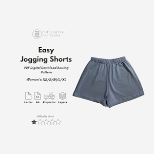 Pode incluir: Calções de jogging azuis claros. A imagem inclui o texto "Easy Jogging Shorts" e "PDF Digital Download Sewing Pattern". O padrão está disponível nos tamanhos XS a XL. O nível de dificuldade é indicado por duas estrelas.
