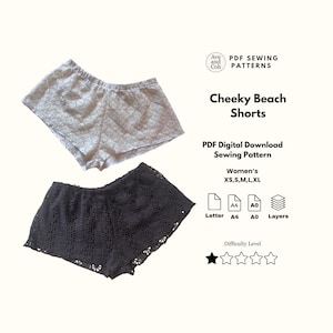 May include: Two pairs of lace shorts, one light gray and one black, are displayed. The image includes text that reads "Cheeky Beach Shorts" and "PDF Sewing Patterns". The shorts are available in sizes XS, S, M, L, and XL.
