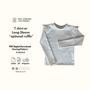 Op de afbeelding: Een witte longsleeve met optionele ruches. De afbeelding is een PDF naaipatroon voor maten 0-3 maanden tot 6 jaar. De tekst op de afbeelding luidt "T shirt or Long Sleeve *optional ruffle*" en "PDF Digital Download Sewing Pattern".